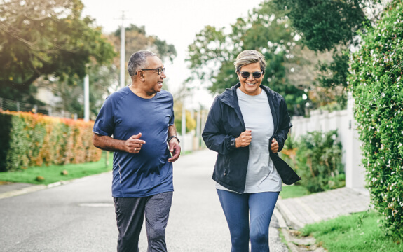 Active senior couple jogging outside